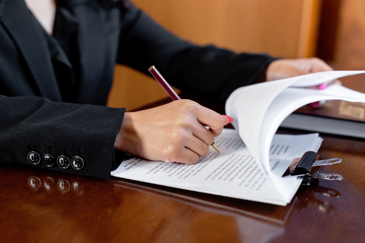 A lawyer marking up a client's documents at an office desk