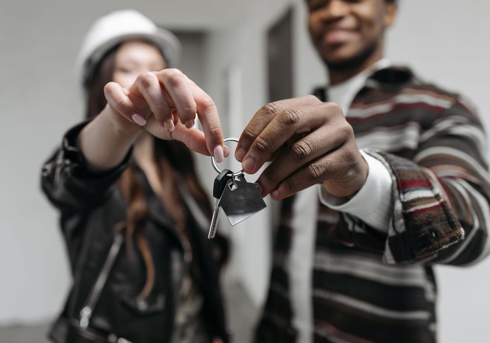 A couple holding the keys to their new home