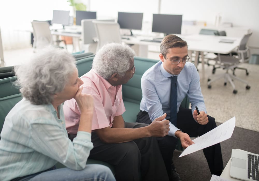An older couple going through documents with their advisor